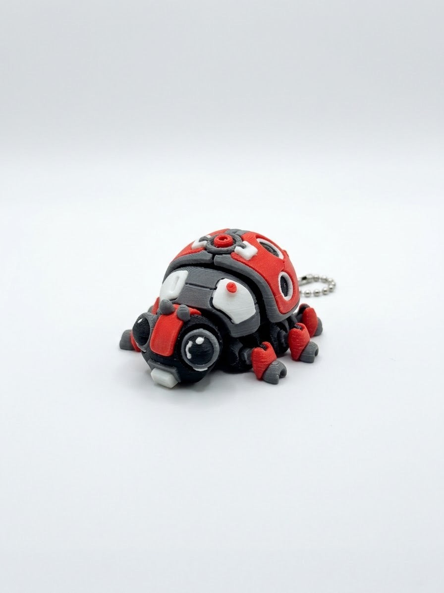 DJM 3D SHOP RoboBeetle +Clicker fidget toy keychain showing a small, colorful beetle with clickable parts on a keyring.