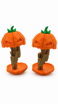 Two orange Jack o’Twister pumpkin figures with green stems on textured bases, front and angled views
